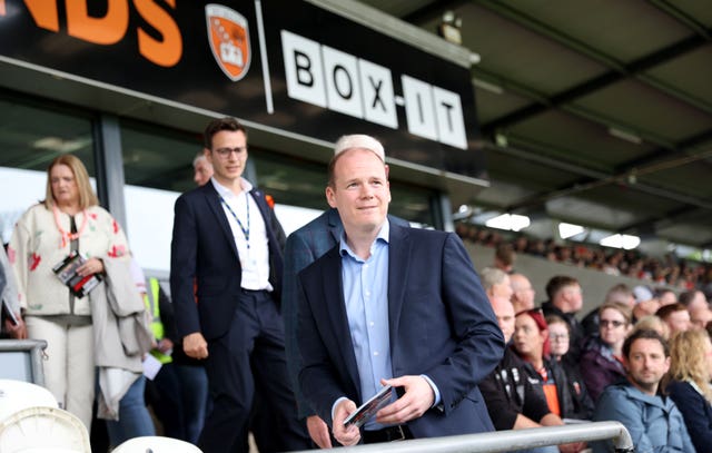 DUP Sports Minister Gordon Lyons takes his seat at his first senior GAA match, the Armagh vs Derry Senior Football Championship encounter at the Athletic Grounds in Armagh