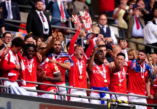 Nottingham Forest skipper Joe Worrall (centre) lifts the Sky Bet Championship play-off final trophy at Wembley