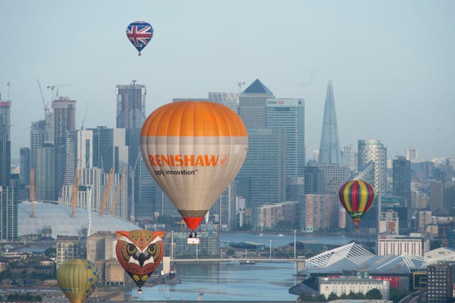 Hot air balloons fly over London