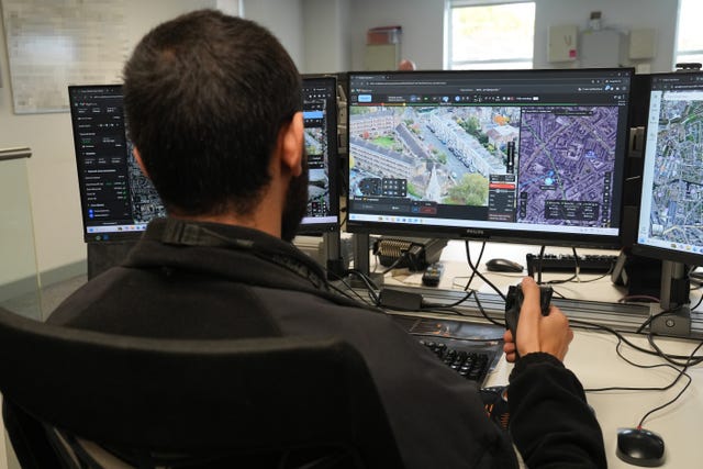 A police officer pilots a drone during a demonstration of the Metropolitan Police’s new 