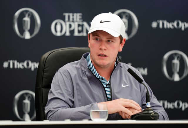 Robert MacIntyre, wearing a grey top and white cap, holds a press conference ahead of the Open at Royal Troon