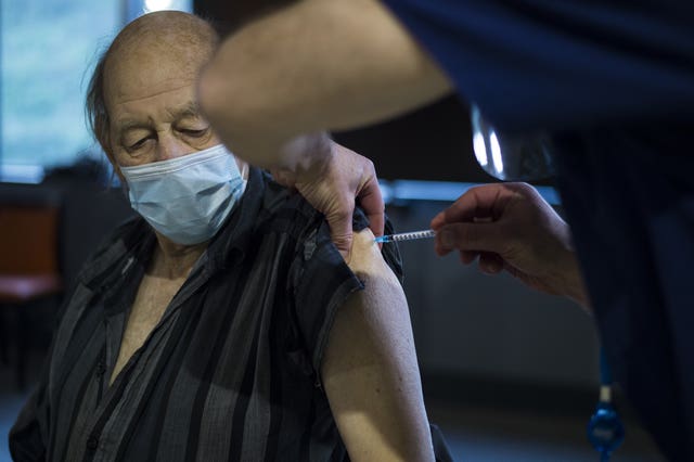 A patient receives the first of two injections with a dose of the Pfizer/BioNtech Covid-19 vaccine