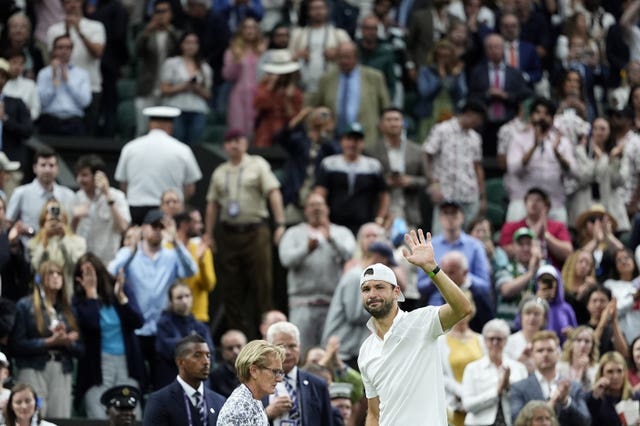 Grigor Dimitrov waves to the crowd after retiring through injury