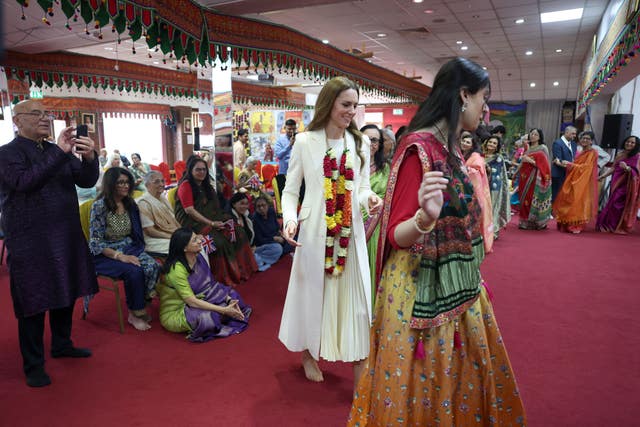 Kate dancing the garba with women in a circle