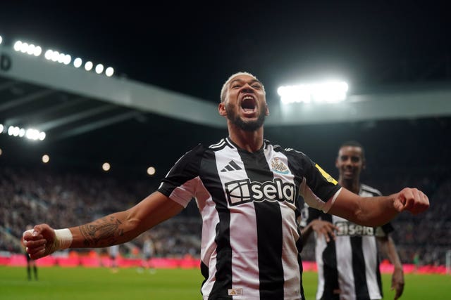 Joelinton celebrates scoring by throwing his arms out