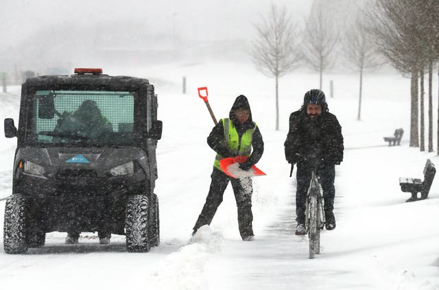 People grit the paths in Helix Park, Falkirk. (PA Images)