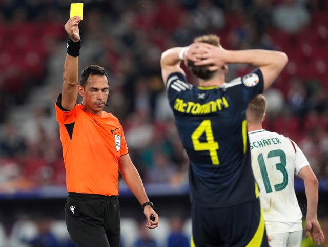 Scotland midfielder Scott McTominay is shown a yellow card during his team's Euro 2024 defeat to Hungary