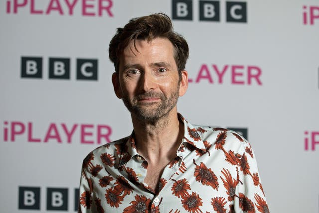 David Tennant (head and shoulders) wearing a patterned shirt in front of a BBC iPlayer-branded backdrop