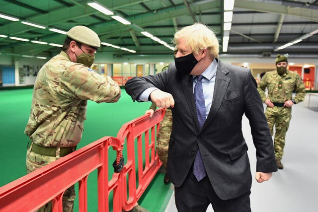 Boris Johnson elbow bumping a soldier on a visit to Scotland