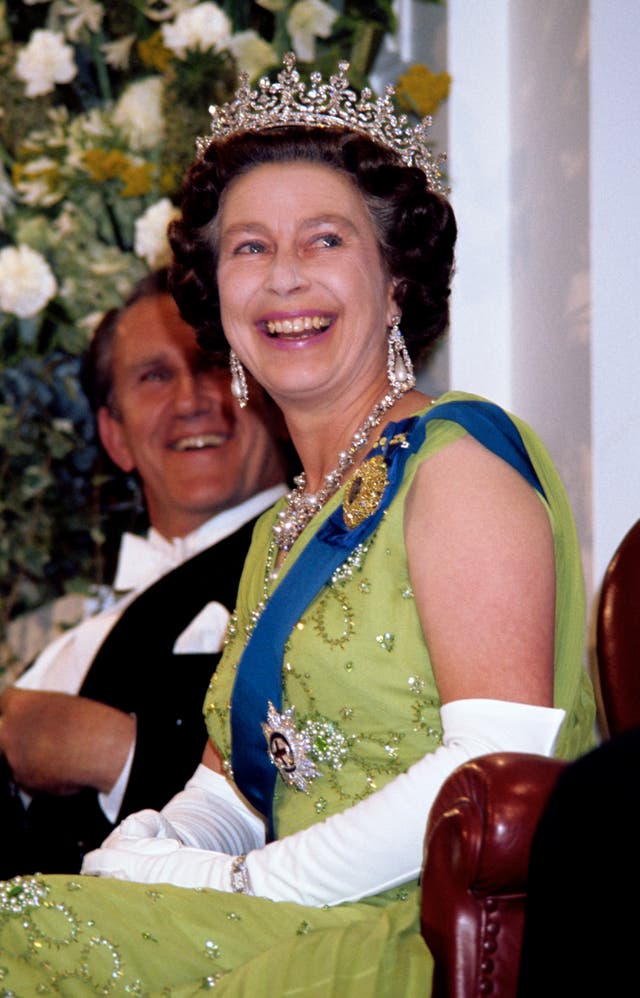 Queen Elizabeth II laughs while she attends a Government reception at Parliament House, Canberra, during her Silver Jubilee tour of Australia 