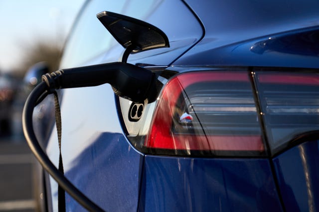 An electric car plugged into a charger