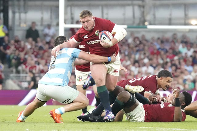 The British and Irish Lions' Tadhg Furlong is tackled by Argentina's Julian Montoya, left