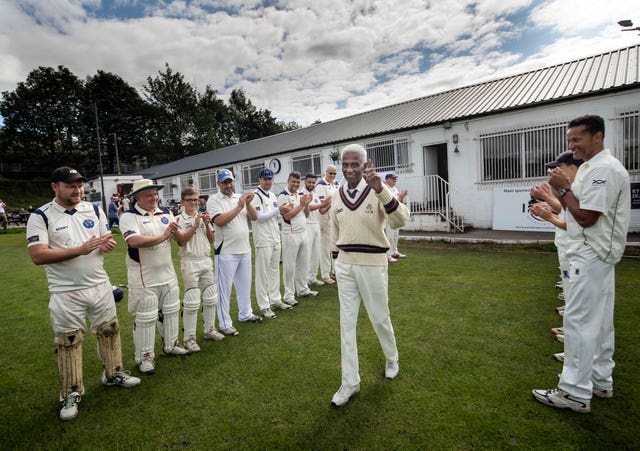 Players form a guard of honour as 85-year-old Cecil Wright walks onto the pitch ahead of playing his last game of competitive cricket at Uppermill Cricket Club in Oldham