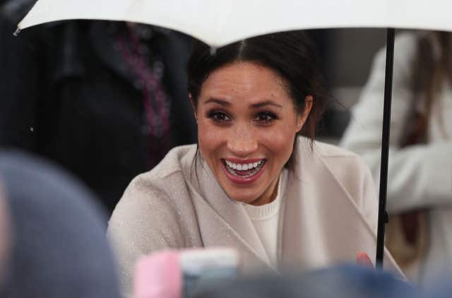 Meghan Markle reacts to well-wishers on a walkabout in Belfast (Brian Lawless/PA)