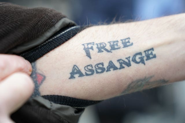 A tattoo on an arm showing Julian Assange's name outside the Royal Courts of Justice in London (Kirsty O'Connor/PA)