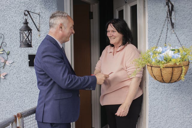 Alex Easton speaking with voter Jacqueline Cathers on a doorstep in Conlig