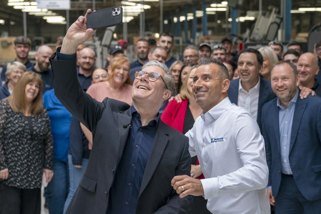 Labour Party leader Sir Keir Starmer takes a selfie alongside chief operating officer Martin Linden and staff during a visit to Window Supply Company in Bathgate, West Lothian