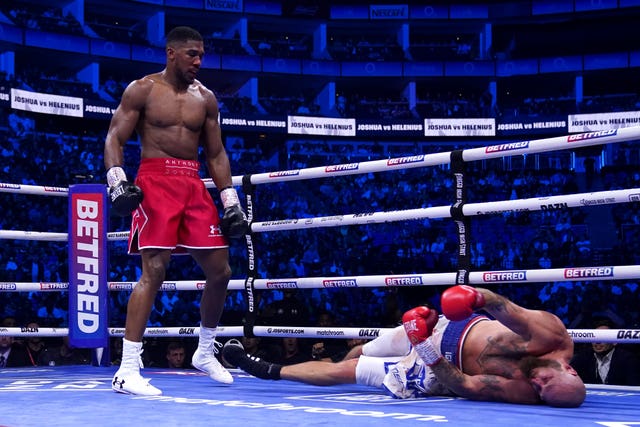 Anthony Joshua, left, stands over Robert Helenius after landing the knockout blow