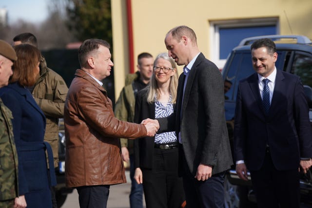 The Prince of Wales is greeted by Polish deputy prime minister and minister of national defence Mariusz Blaszczak as he arrives for a visit to the 3rd Brigade Territorial Defence Force base in Rzeszow, Poland