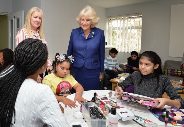 Camilla meets youngsters in an arts and crafts area