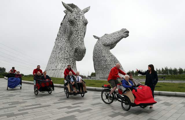 Public Health and Sport Minister Aileen Campbell (right) chats with Mary Duncan, 90, Jim Taylor, 96, and volunteer Harry Wilson at the Kelpies in Falkirk (Andrew Milligan/PA)