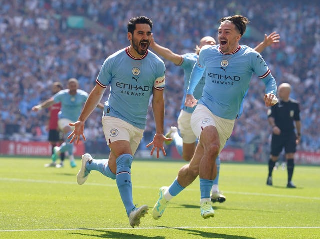 Ilkay Gundogan (left) celebrates scoring in the FA Cup final