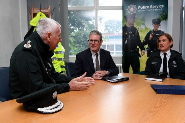 Three people sit around a table