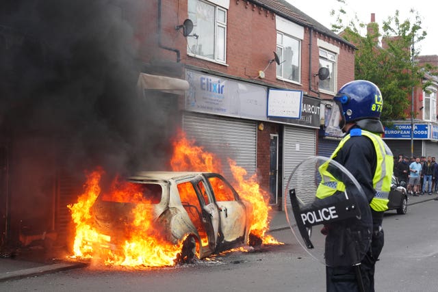 A car burns on Parliament Road, in Middlesbrough, during an anti-immigration protest.