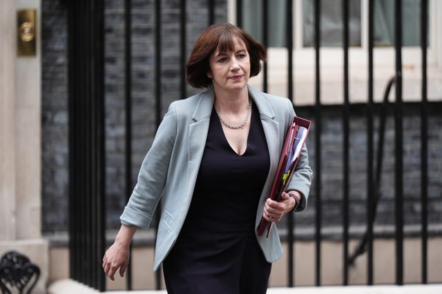 Bridget Phillipson walking on Downing Street, with her red ministerial folder under one arm
