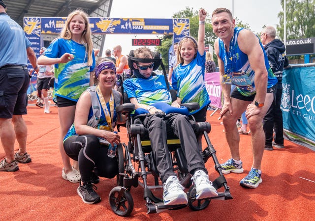 Burrow, pictured alongside wife Lindsey, daughters Macy and Maya, and Kevin Sinfield at the Leeds Marathon in May