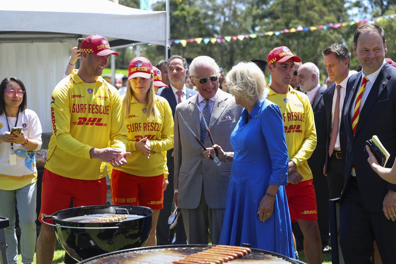 Charles and Camilla take charge of the tongs at Sydney ‘sausage sizzle
