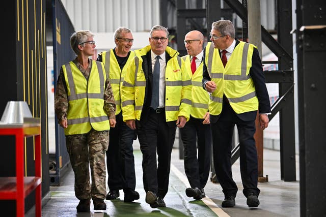 Prime Minister Keir Starmer (centre), Defence Secretary John Healey (second right) and managing director of BAE Systems’ naval ships business Simon Lister (right) speak to a member of staff during a visit to BAE Systems in Govan, Glasgow, to launch the strategic defence review