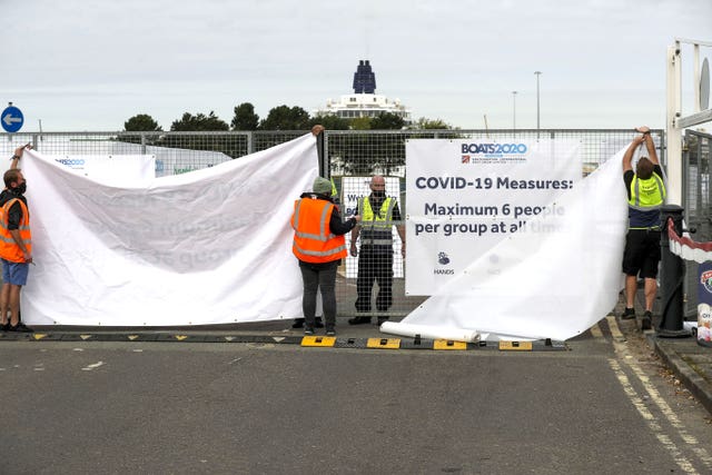 Staff put up screens at the BOATS2020 show 