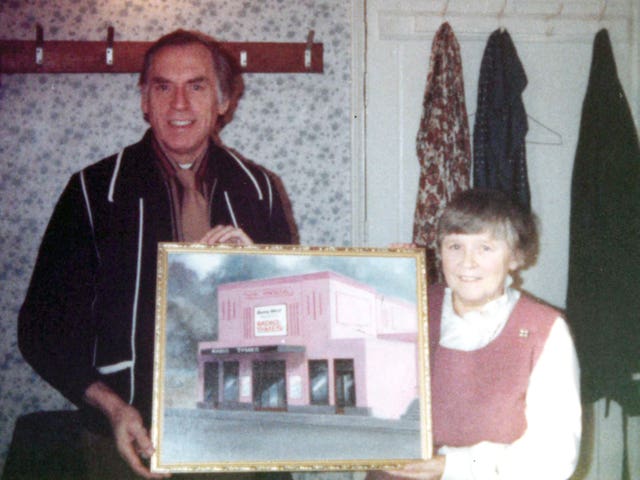 Joyce Dowding and Larry Grayson holding a photograph of the Regent Cinema in Redcar (Family handout/PA)