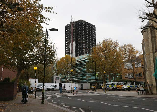 The charred Grenfell Tower looms over the west London neighbourhood (Jonathan Brady/PA)