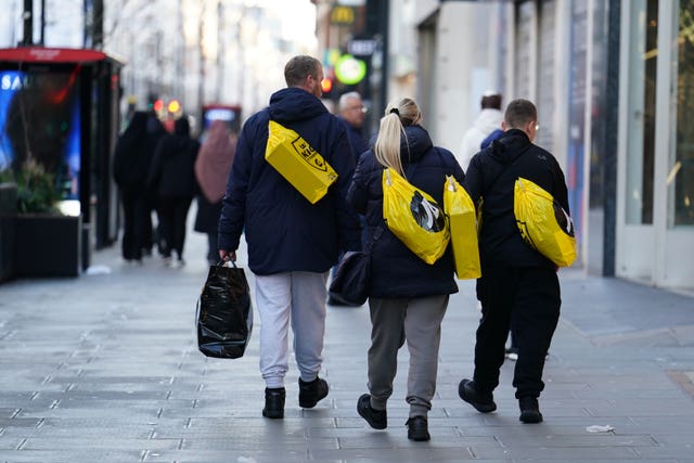A handful of shoppers walk along Oxford Street in central London during the Boxing Day sales 