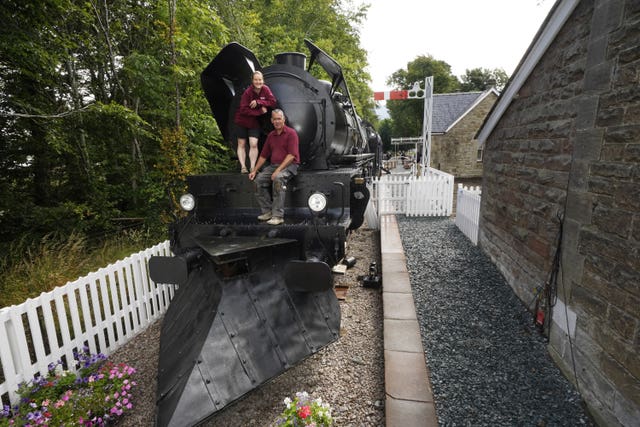Simon and Diana Parums with their full-size steam train with carriages, tracks and platform as they converted and restored Bassenthwaite Lake station in Keswick