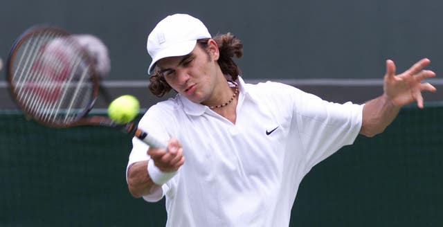 An 18-year-old Roger Federer in action during his first-round defeat to Russia's Yevgeny Kafelnikov at Wimbledon in 2000