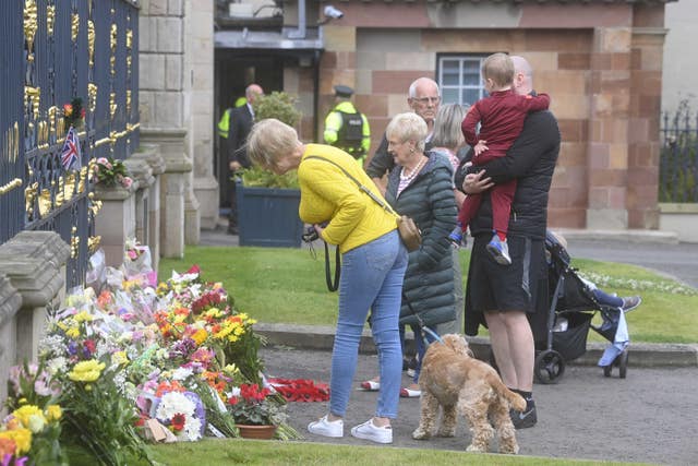 People pay their respects at the gates of Hillsborough Castle following the Queen's death 