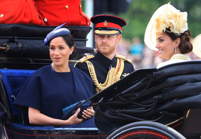 The Duke and Duchess of Sussex and the Duchess of Cambridge make their way along The Mall to Horse Guards Parade during the 2019 Trooping ceremony. Gareth Fuller/PA Wire