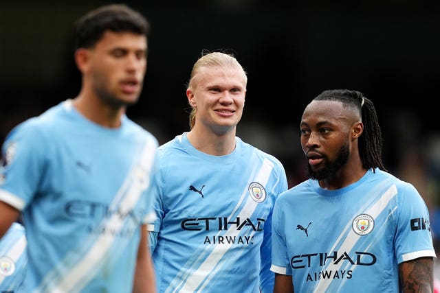 Manchester City’s Erling Haaland (centre) smiles