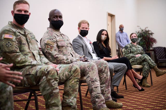 The Duke and Duchess of Sussex, with service members during a visit to Joint Base McGuire-Dix-Lakehurst in New Jersey (Lee Morgan/AP)