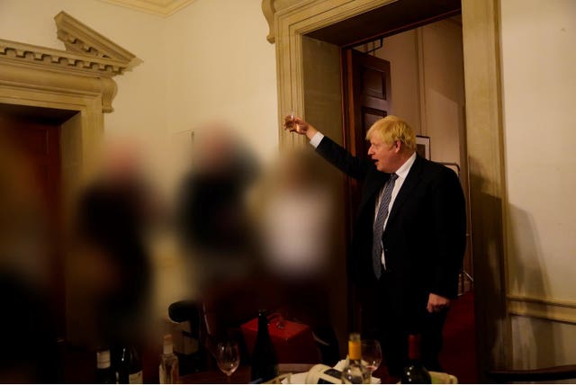 Boris Johnson raises a glass at a drinks gathering in Downing Street. The images of other participants have been obscured