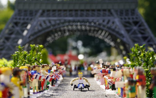 A Lego Hannah Cockroft in front of a Lego Eiffel Tower