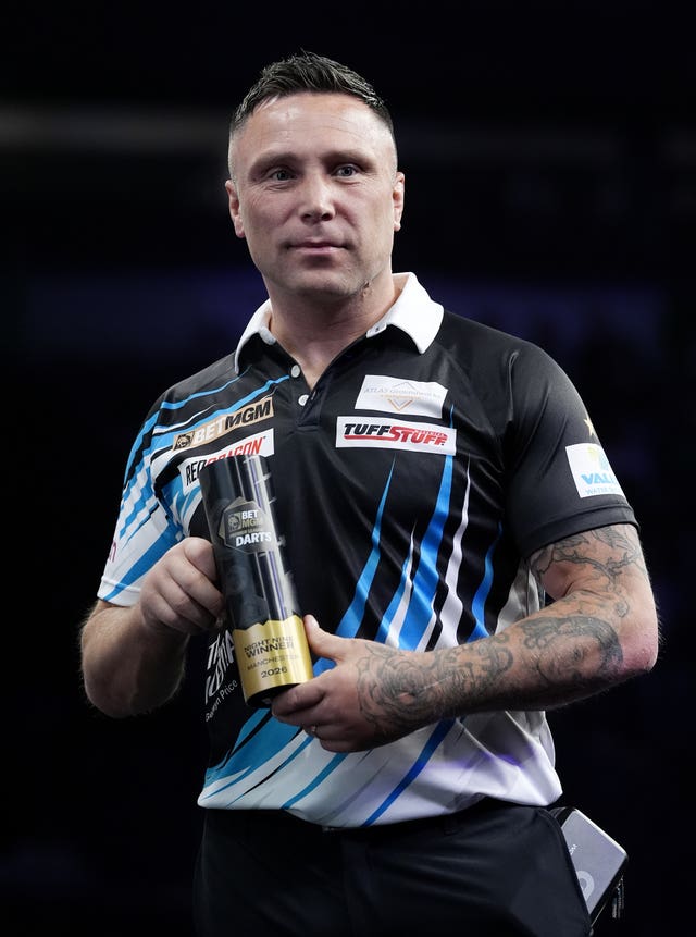 Gerwyn Price poses with the trophy