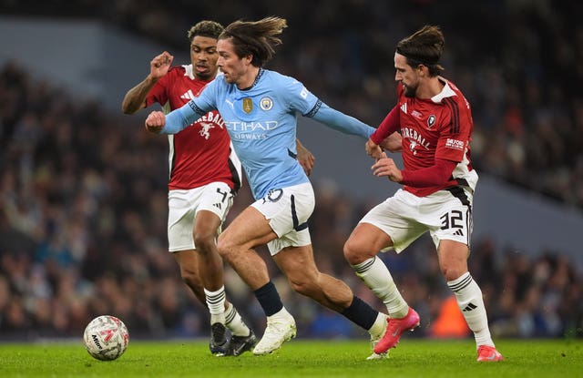 Jack Grealish runs with the ball in Manchester City's FA Cup tie against Salford