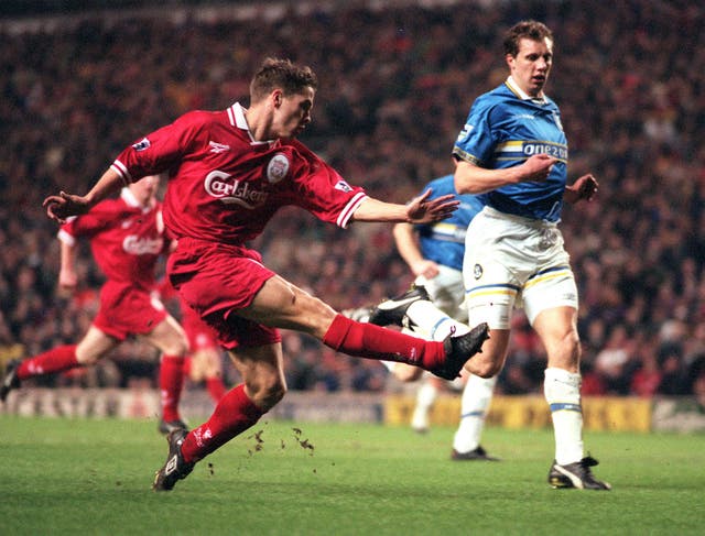 Michael Owen, left, shoots at goal against Everton