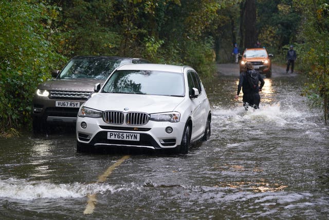 A broken down car in floodwater near Derwentwater, Keswick (Owen Humphreys/PA)