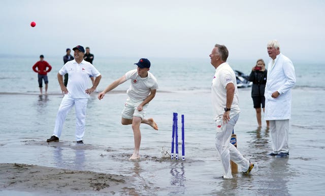 A bowler releases the ball after a soggy run-up (Andrew Matthews/PA)