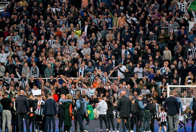 Newcastle fans celebrate at the end of the game 